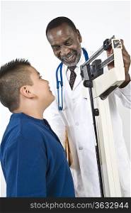 Doctor examining pre-teen (10-12) boy