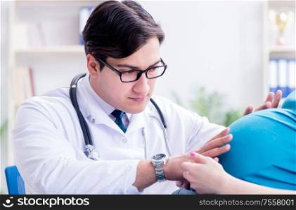 Doctor examining pregnant female patient in hospital. The doctor examining pregnant female patient in hospital