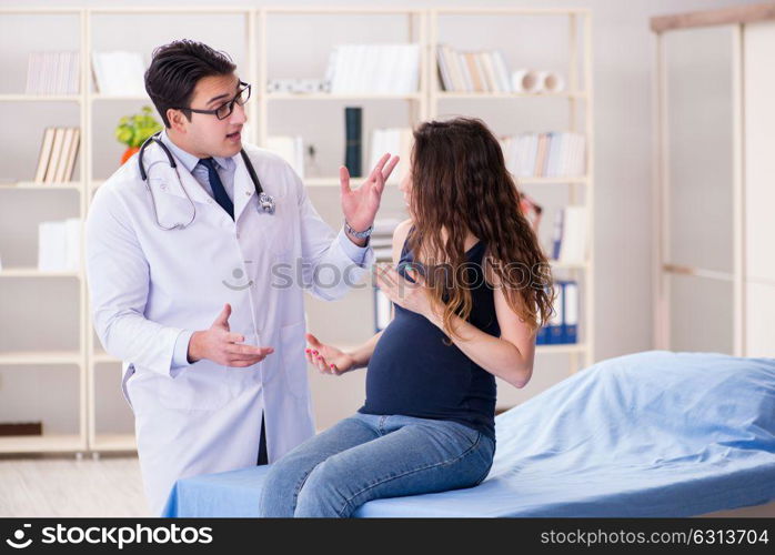 Doctor examining pregnant woman patient