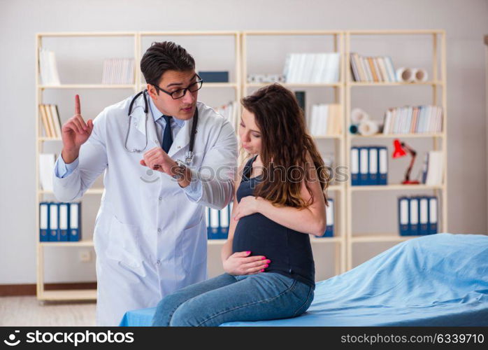 Doctor examining pregnant woman patient