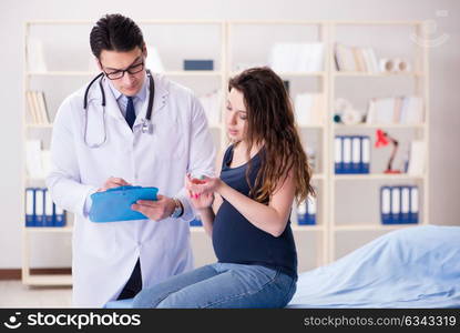 Doctor examining pregnant woman patient