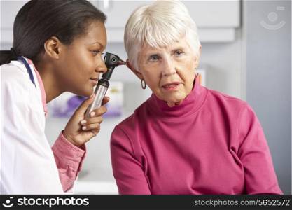 Doctor Examining Senior Female Patient&#39;s Ears