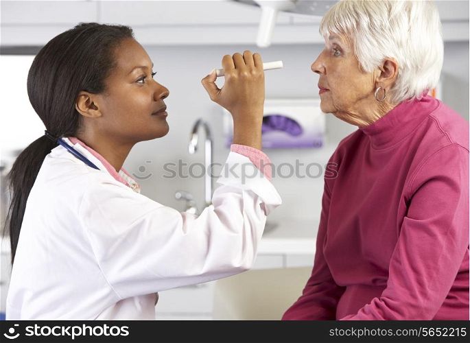 Doctor Examining Senior Female Patient&#39;s Eyes