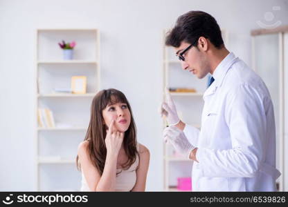 Doctor examining the skin of female patient