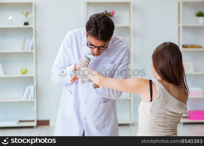 Doctor examining the skin of female patient