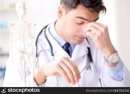 Doctor explaining human body on skeleton