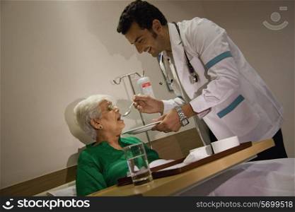 Doctor feeding his patient
