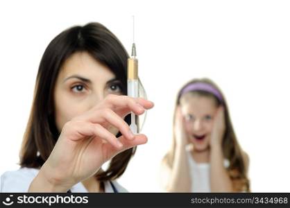 Doctor getting ready to make an injection to a child
