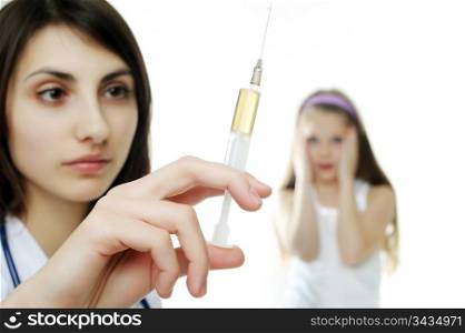 Doctor getting ready to make an injection to a young girl