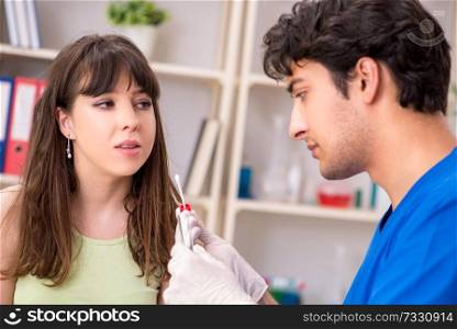 Doctor getting saliva test s&le in clinic hospital