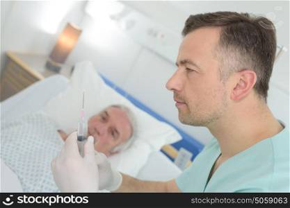 doctor giving an injection to a mature patient