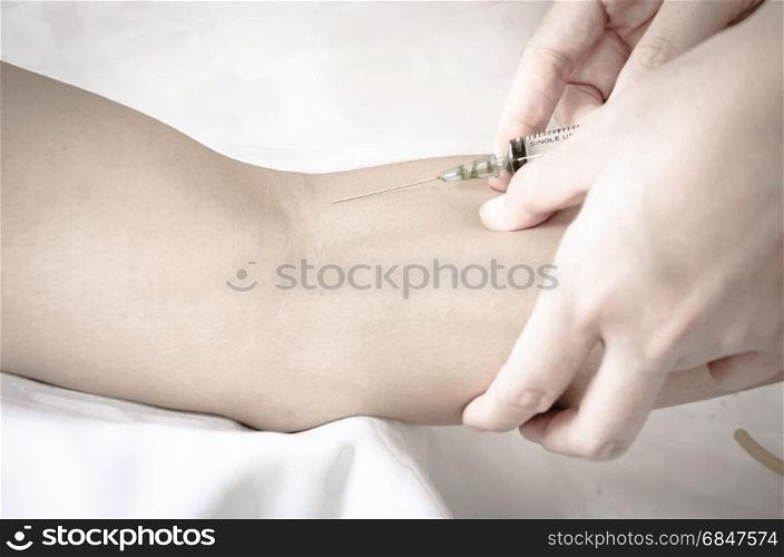 Doctor giving an injection to a patient