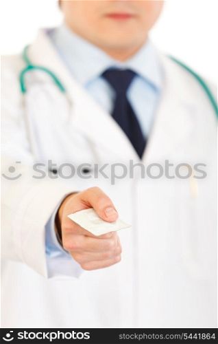 Doctor giving condom isolated on white. Close-up.&#xA;