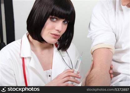 Doctor giving her patient a shot