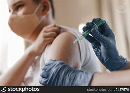doctor giving kid vaccine while wearing gloves