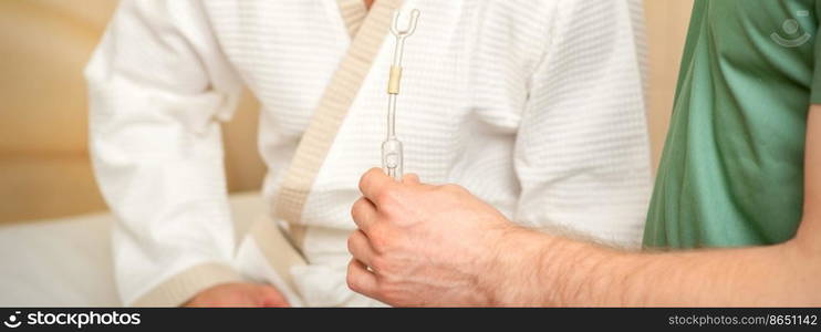 Doctor giving nasal inhalator with essential oil Maholda to a male patient in spa. Doctor giving nasal inhalator with essential oil Maholda to a male patient in spa.