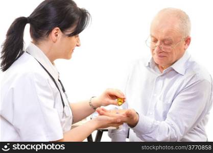 doctor giving the medicine to a senior man. focus on the pills. doctor giving the medicine to a senior man