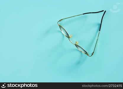 doctor glasses with soft shadow over green desk background