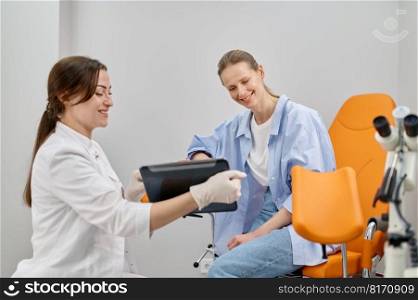 Doctor gynecologist showing result of medical exam to patient. Gynecology and treatment of gynecological diseases. Doctor gynecologist showing result of medical exam to patient