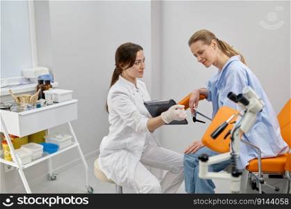 Doctor gynecologist showing result of medical exam to patient. Gynecology and treatment of gynecological diseases. Doctor gynecologist showing result of medical exam to patient