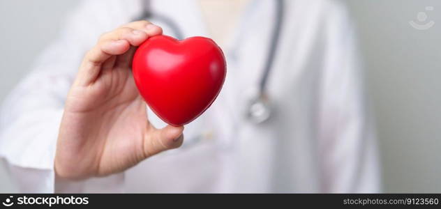 Doctor hand holding red heart shape in hospital. love, donor, world heart day, world health day, CSR donation and Insurance concepts