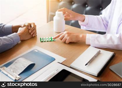 doctor hand holding tablet of drug and explain to patient in hospital room.. doctor hand holding tablet of drug and explain to patient in ho