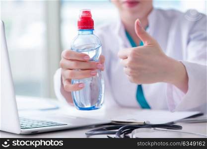 Doctor hand with fresh water in medical concept. The doctor hand with fresh water in medical concept