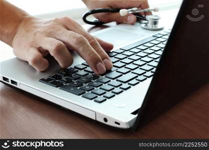 Doctor hand working with laptop computer in medical workspace office as concept