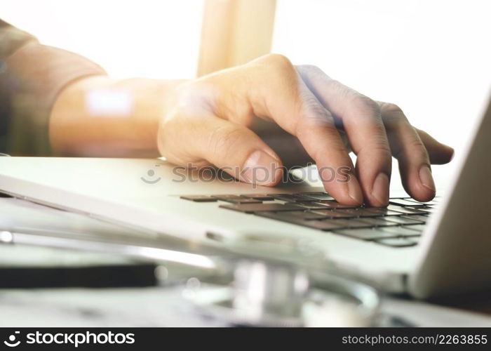 Doctor hand working with laptop computer in medical workspace office as concept