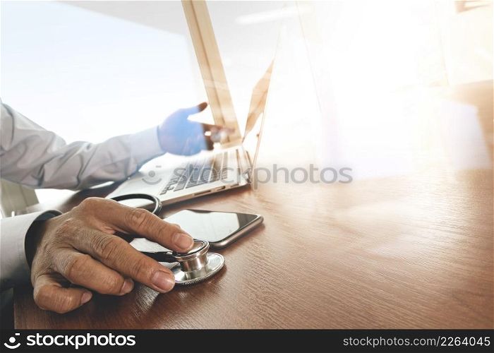 Doctor hand working with laptop computer in medical workspace office as concept