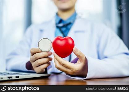 Doctor hands holding red heart, health care, love, organ donation, mindfulness, wellbeing, family insurance and CSR concept, world heart day, world health day, world mental health day, praying concept