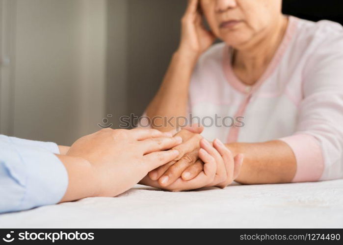 Doctor hands together holding senior woman patient