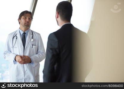 doctor handshake with a patient at doctors bright modern office in hospital