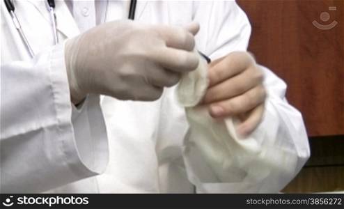 doctor has finished work and removes gloves.