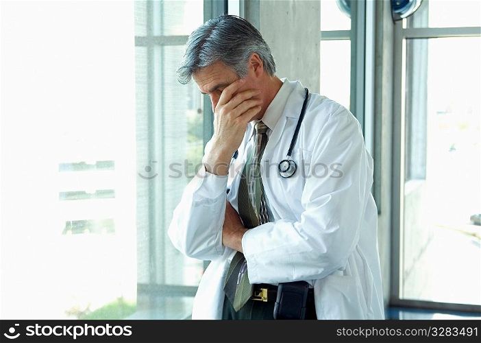 Doctor having a personal moment of sadness.