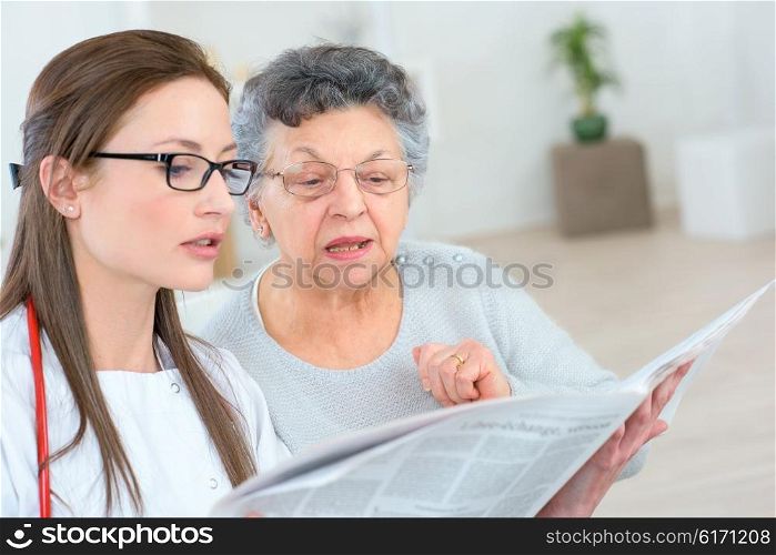 Doctor helping a patient to read