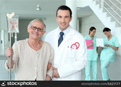 Doctor helping his patient walk