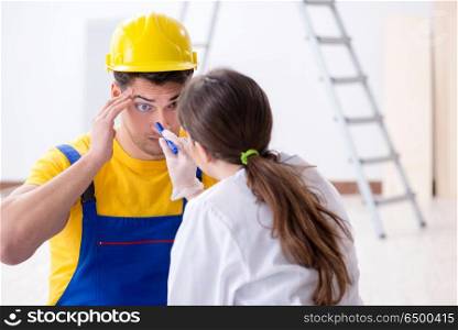 Doctor helping injured worker at construction site