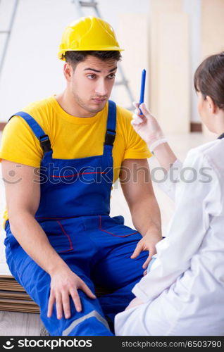 Doctor helping injured worker at construction site