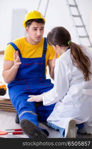 Doctor helping injured worker at construction site