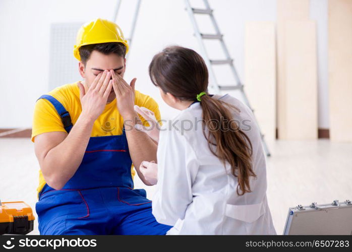 Doctor helping injured worker at construction site