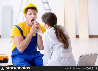 Doctor helping injured worker at construction site