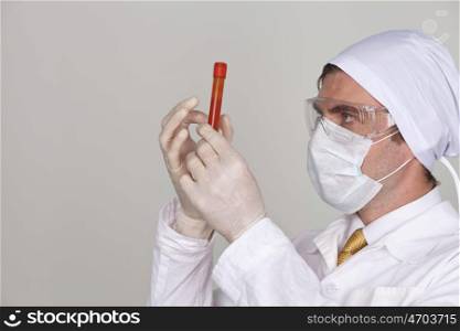 Doctor holding a beaker of blood