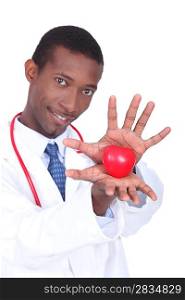 Doctor holding a plastic heart in his hands