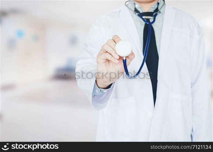 Doctor holding a stethoscope on background of Hospital ward