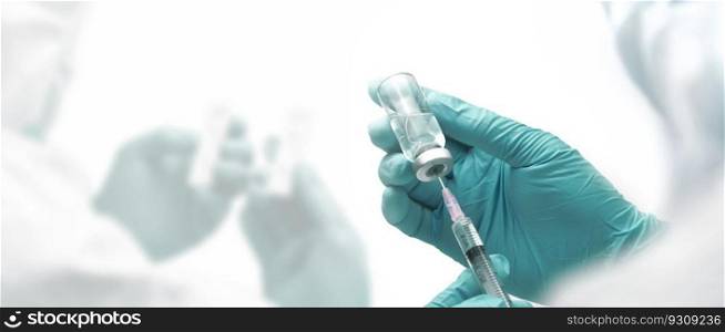 Doctor holding a syringe with a vaccine, close up, medical concept.