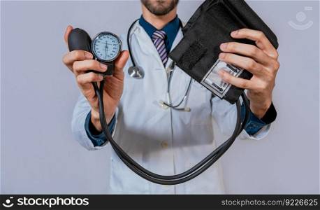 Doctor holding blood pressure monitor isolated. Doctor hands holding manual sphygmomanometer isolated