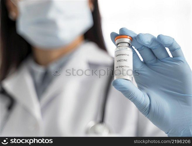 doctor holding coronavirus vaccine recipient her hand