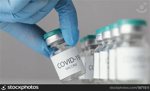doctor holding covid 19 vaccine bottle. High resolution photo. doctor holding covid 19 vaccine bottle. High quality photo
