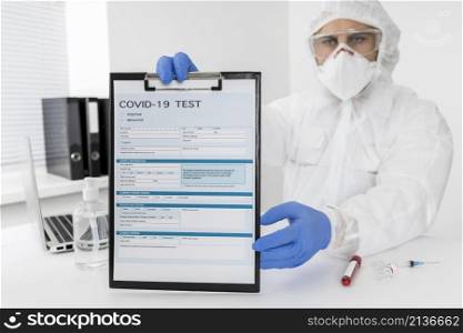 doctor holding covid test form